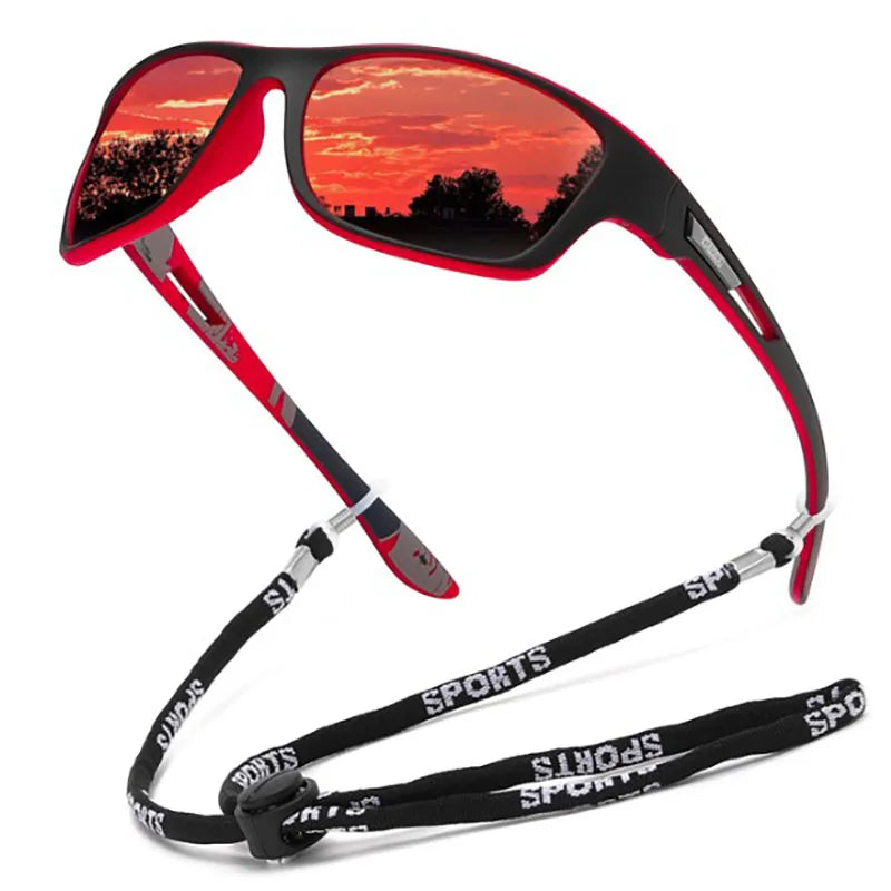 Sunglasses with a red reflective lens and black and red strap on a white background
